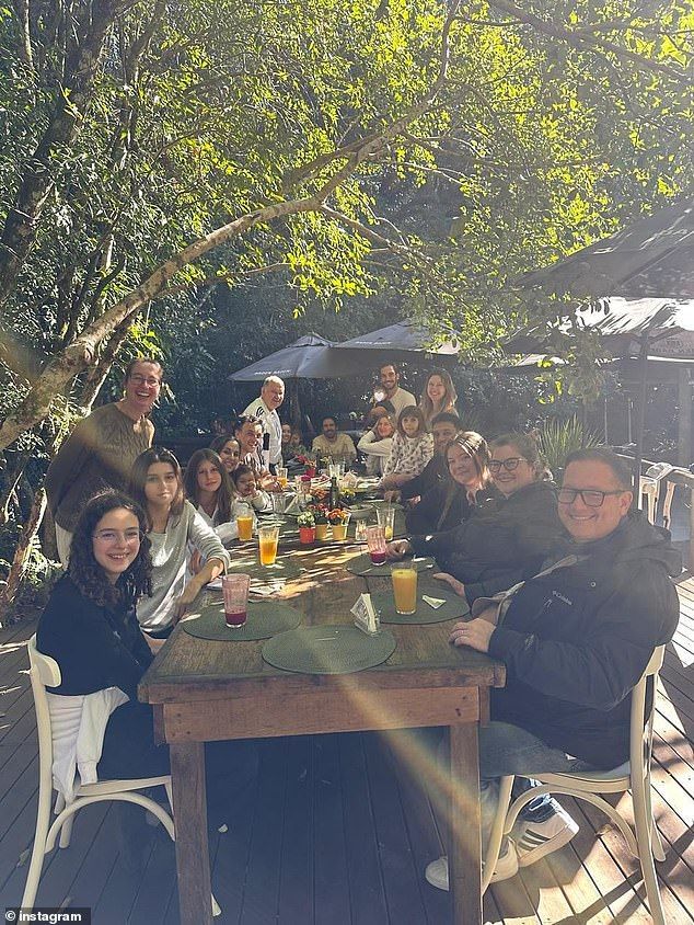 Gisele revealed that her boyfriend Joaquim had joined her for the family trip. He stood next to her and held their son, whose face was again covered up with a white heart, as they posed for a large family photo at an outdoor dining table on a wooden deck