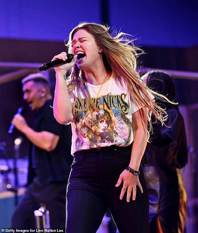 Kelly has chopped inches from her ordinarily long hair; pictured earlier this month in Las Vegas