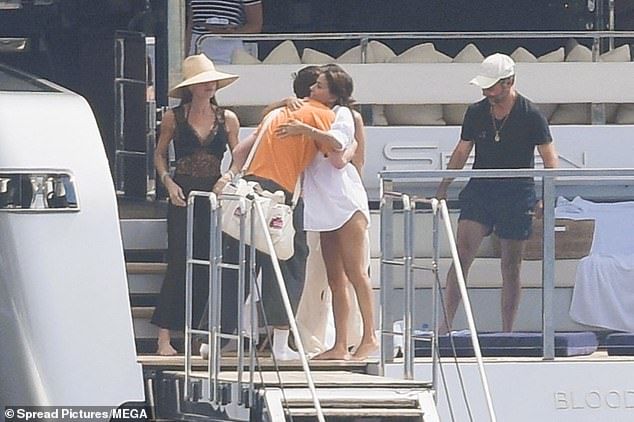 Eva Longoria, 50 - a close family friend of the Beckhams - was also spotted hugging Cruz on their multi-million pound vessel with her husband Jose Baston, 57, right