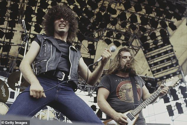 Paul Mario Day and guitarist Kenny Cox of heavy metal group More are seen performing on stage at the Monsters of Rock festival at Donington Park in Leicestershire in August 1981
