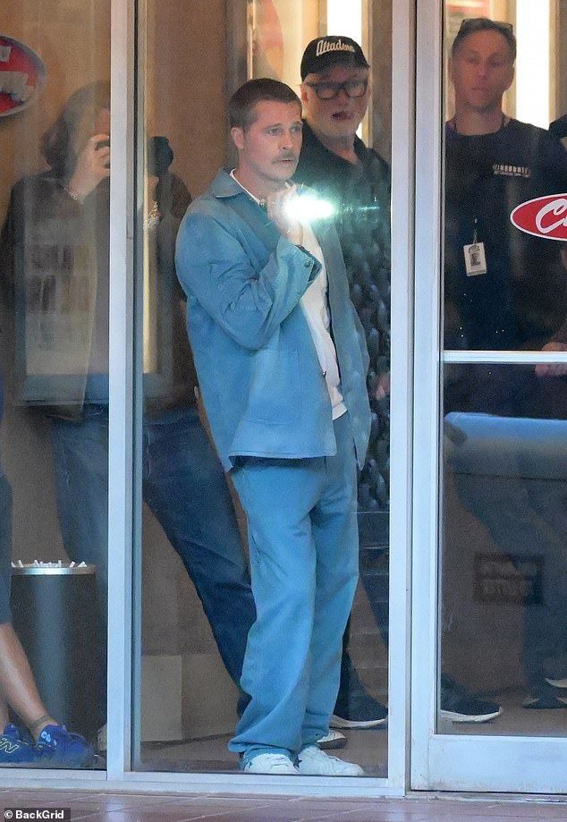 Brad was dressed casually in a blue open shirt with matching loose fitting trousers and a white vest