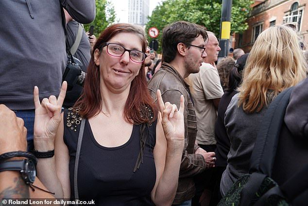 Black Sabbath fan Amy Maybury is seen here giving a the recognised hard rock hand gesture