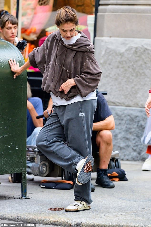 Katie Holmes looked frustrated as she stepped in dog poo while continuing to film upcoming trilogy Happy Hours, after ex Tom Cruise went public with girlfriend Ana De Armas