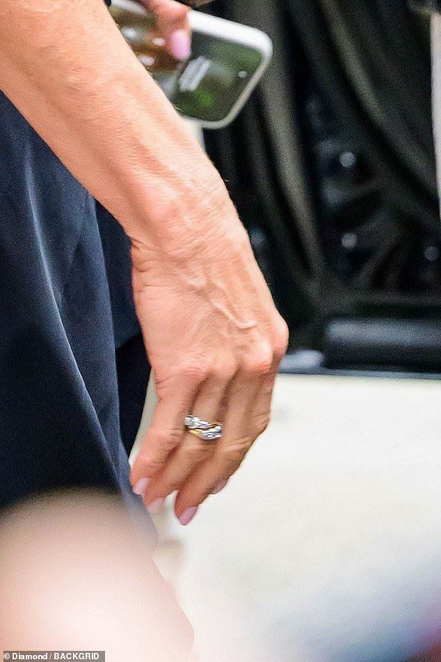 She sported some striking jewelry, including a gold band decorated with sparkling diamonds that she wore on her right ring finger