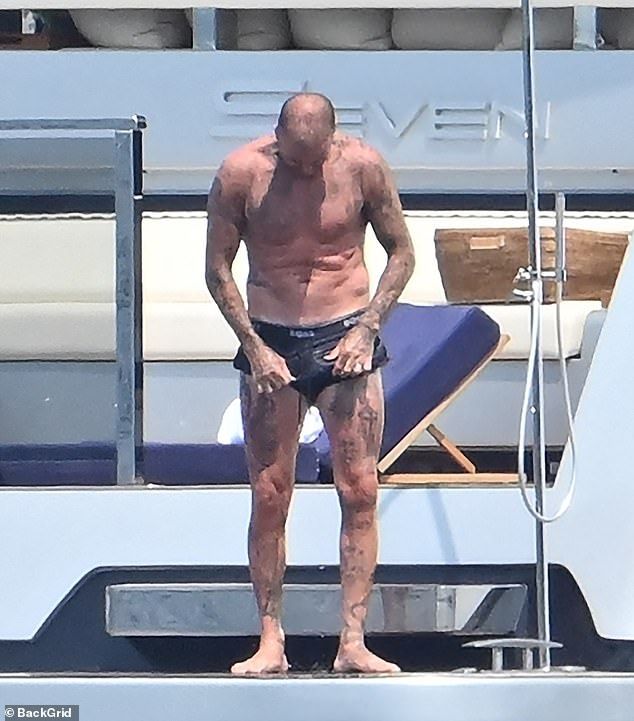 David was seen readjusting his skimpy ensemble after hitting the high seas