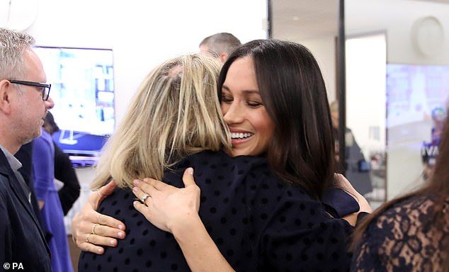 'She gave me a big old bear hug, the kind that makes you feel at ease  particularly when you are being presented to assorted royals in front of a bank of baying photographers,' Bryony writes