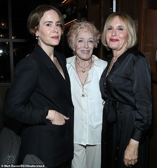 For the evening, Holland donned a chic white silk shirt paired with a neck tie, while Sarah opted for a sleek black suit