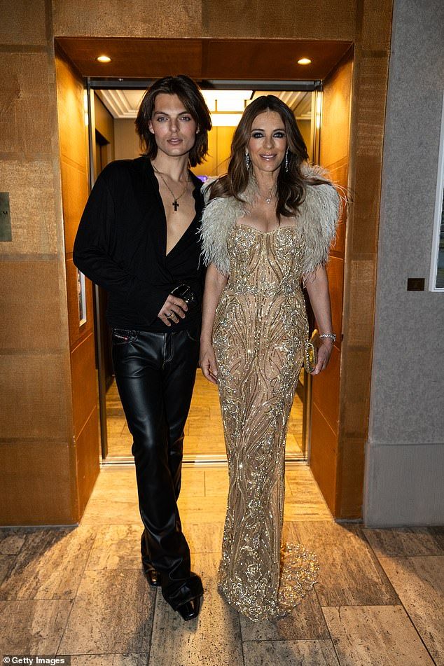 Damian's trip meant he was absent from his mother Elizabeth's new reality show premiere in London earlier this week as she was supported by her boyfriend Billy Ray Cyrus