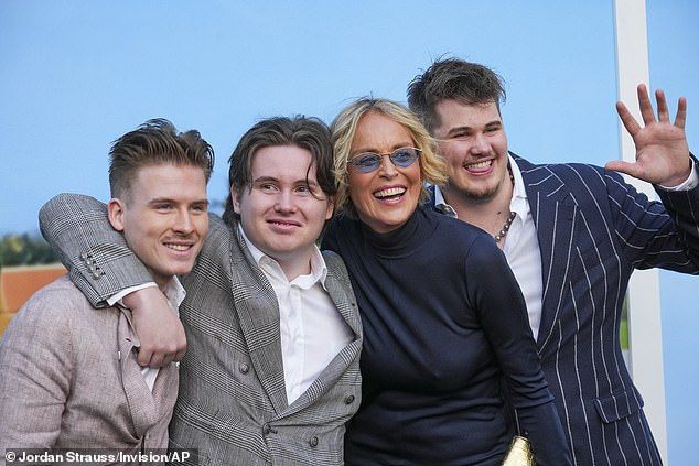 The Beauty of Living Twice author beamed as she was surrounded by her sons