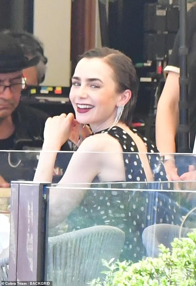Lily Collins looked as chic as ever in a polka dot dress as she filmed scenes for the upcoming fifth season of Emily In Paris in Venice on Friday