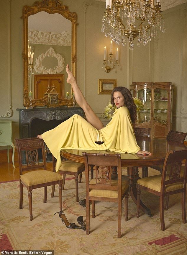 In the shoot Alicia looked nothing short of sensational as she flaunted her long toned legs in a figure-hugging silk dressed before posing seductivly on a bed wrapped in a fur stole