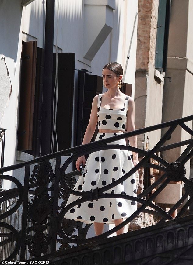 She appeared to be standing on a balcony of some sort as the cast and crew got to it