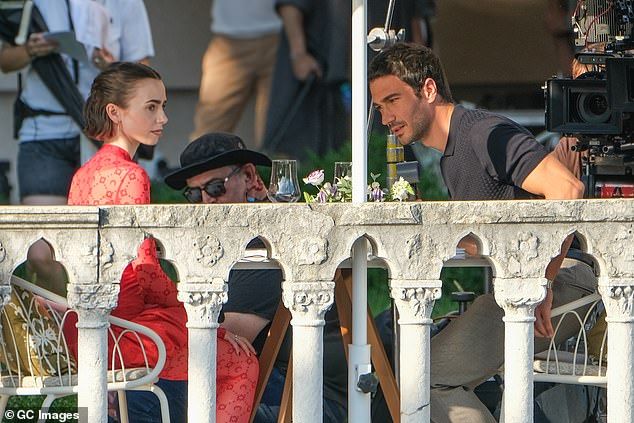 Lily Collins and Eugenio Franceschini are seen filming on the set of Emily In Paris on August 16