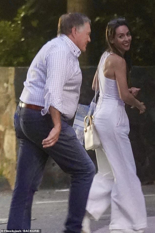 Hudson, dressed head-to-toe in white, smiled while out with the NFL legend