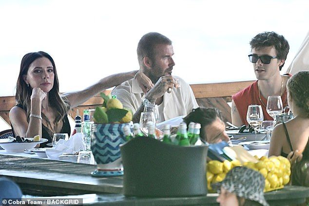 Victoria rested her arm on David's shoulder