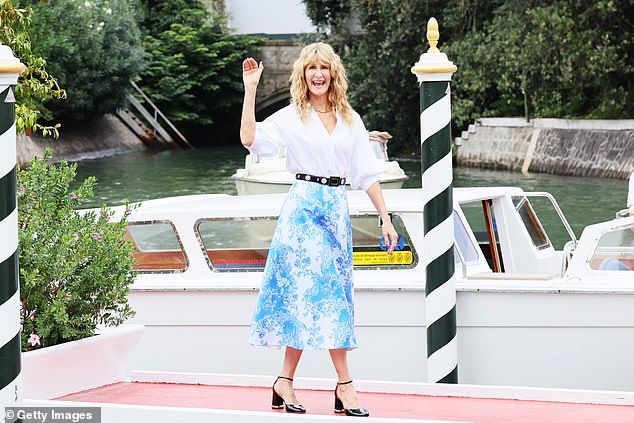 She put on an animated display as she waved and smiled at passersby while arriving via water taxi before stepping onto the jetty