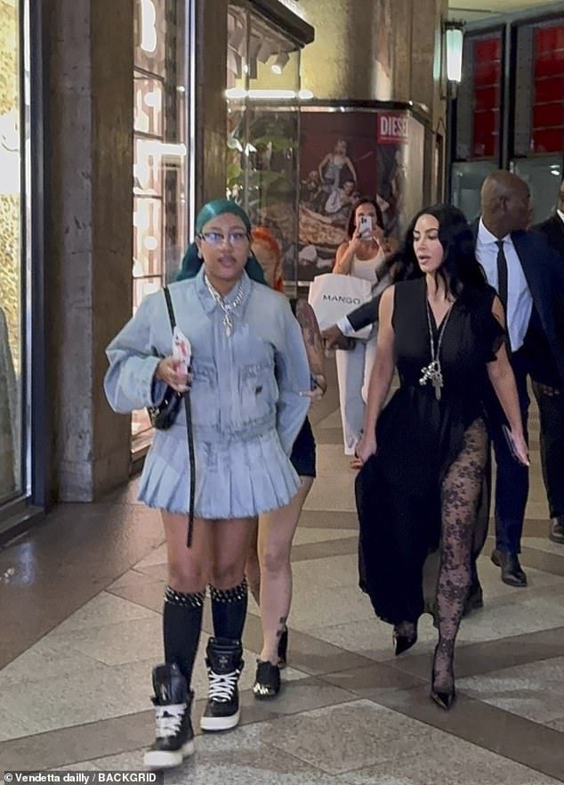She paired the ensemble with knee high diamond bejewelled black socks and chunky black trainers