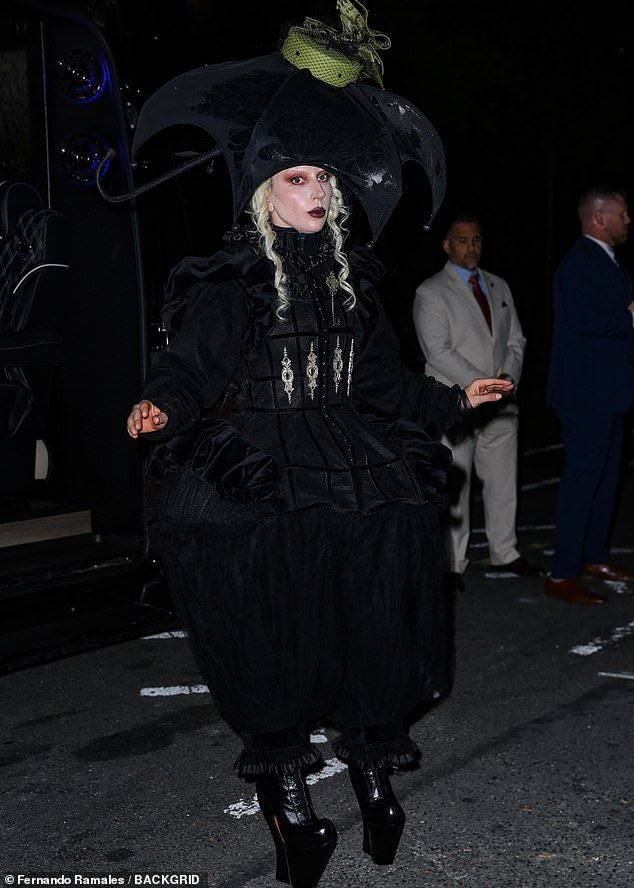 The outfit featured a ruffled neck and long sheer billowing sleeves