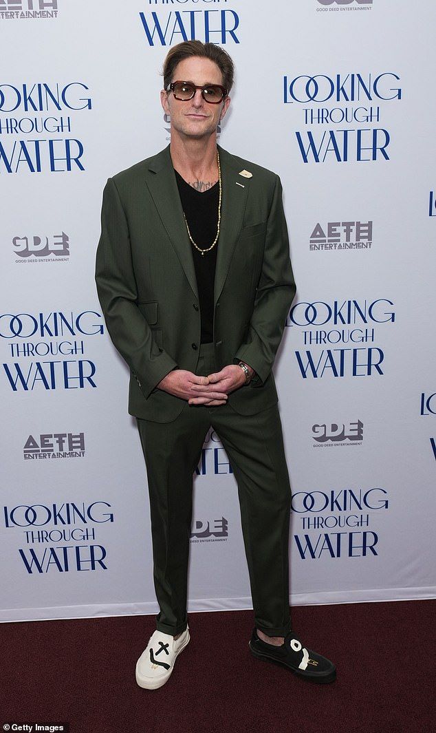 He looked the spitting image of his A-list father as he made a rare public appearance for the New York premiere of Looking Through Water on Wednesday - but can YOU guess who he is?
