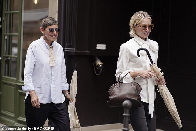 Their outfits were perfectly in sync, right down to matching white scarf ties and designer sunglasses