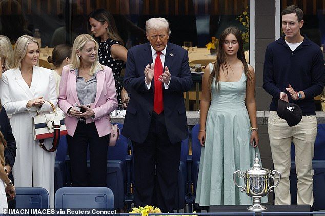 Karoline Leavitt (far left) holds a GucciDionysus bag with her white outfit, next to Pam Bondi in pink, Donald Trump, his granddaughter Arabella Kushner in teal, and her father Jared Kushner holding a baseball hat