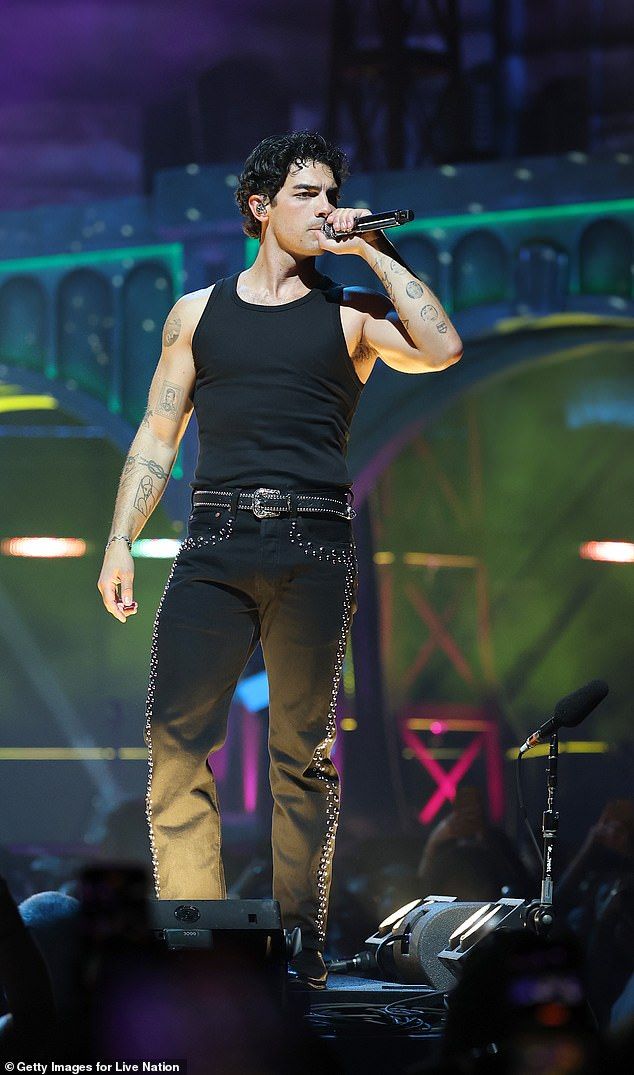 Joe Jonas, 36, shut down fan theories about a recent viral backstage video of him; Pictured performing in Inglewood,California on Saturday
