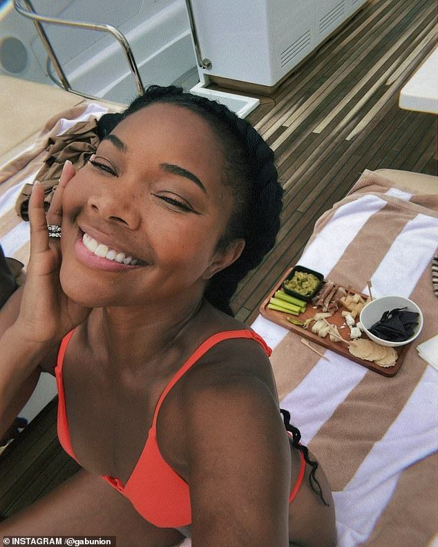 The Bring It On star modeled a skimp neon orange bikini that showed off her fit figure