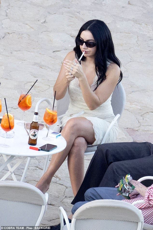 She was seen sipping on Aperol Spritz and smoking