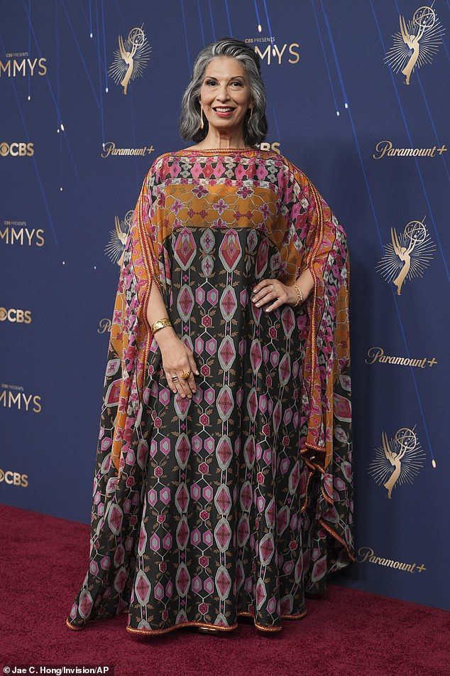 Gilmore Girls starRose Abdoo, 62, was largely swamped by her choice of gown - she was left completely covered by the geometric patterned dress in hues ofgreen, orange and pink that draped to the floor with batwing style sleeves