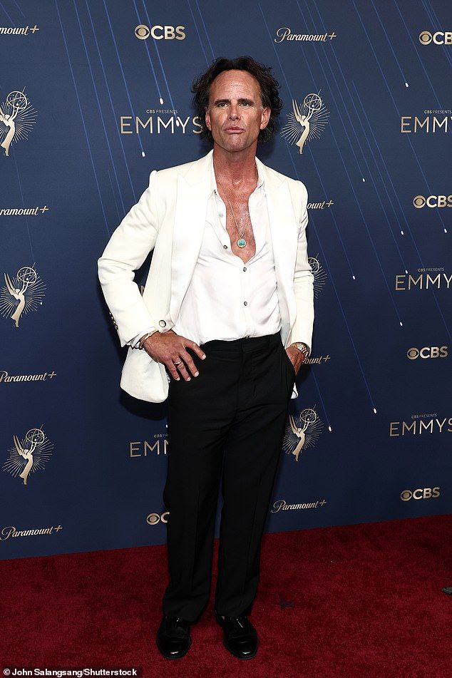 The actor looked handsome as ever in a white shirt he left partly unbuttoned and a matching suit jacket. He completed the look with black pants