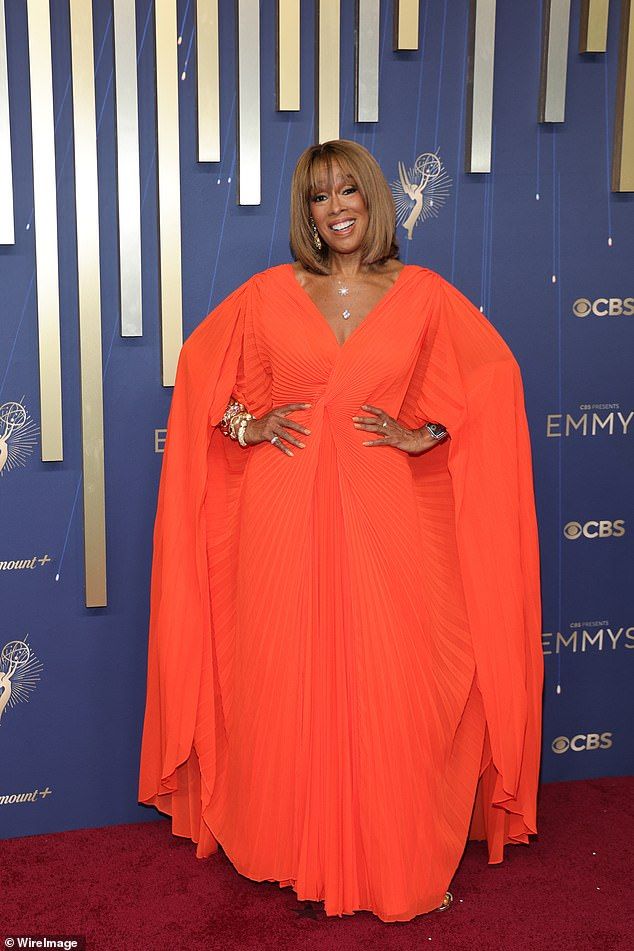 Gayle King was a vision in a bold orange dress that accentuated her trim waist at the 2025 Emmys - while an attached cape added some major glamour