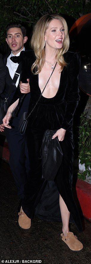Meghann was joined by a male friend who held onto her arm as they headed into the bash