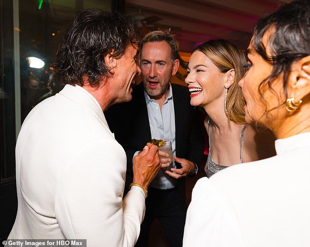 The British actress, 31, enjoyed burgers as she danced the night away with her co-stars but seemingly kept her distance from Walton (L)