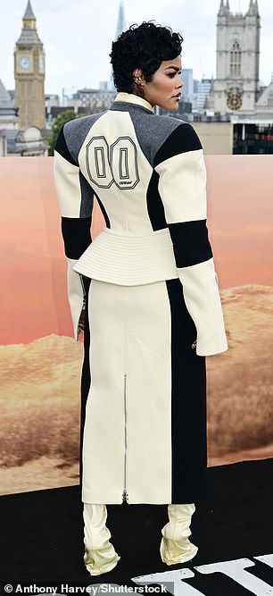 Teyana put on a striking display in a sculpted longline cream, black and grey racing jacket