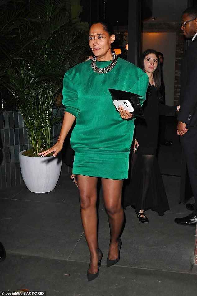 Also opting for a flamboyant look was Tracee Ellis Ross, 52, who wowed in an oversized emerald green shift dress that she paired with sheer tights and a silver necklace
