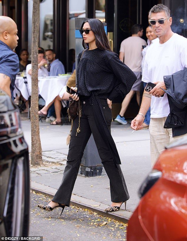The Houdini singer, 30, cut a chic look with a black polka dot blouse along with skinny black jeans for the outing with her dad