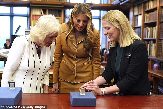 Earlier today, Queen Camilla and the First Ladylooked at miniature dolls' house books during a visit to the Royal Library at Windsor Castle