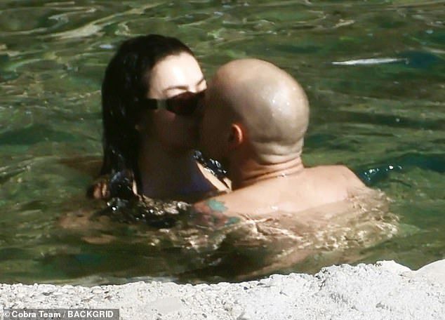 Charli XCX and The 1975 drummer husband George Daniel packed on the PDA as they kissed in the ocean ahead of their gorgeous Italian wedding last week