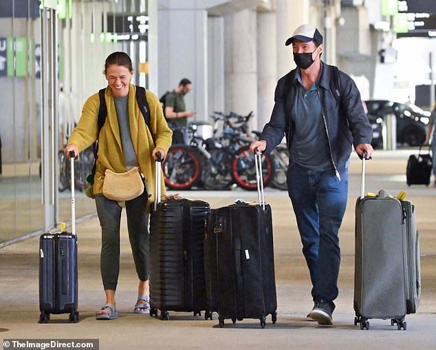 Hugh Jackman, 56, (right) and Sutton Foster, 50, (left) were spotted together for the first time in months on Thursday as they arrived together at Laguardia Airport, New York