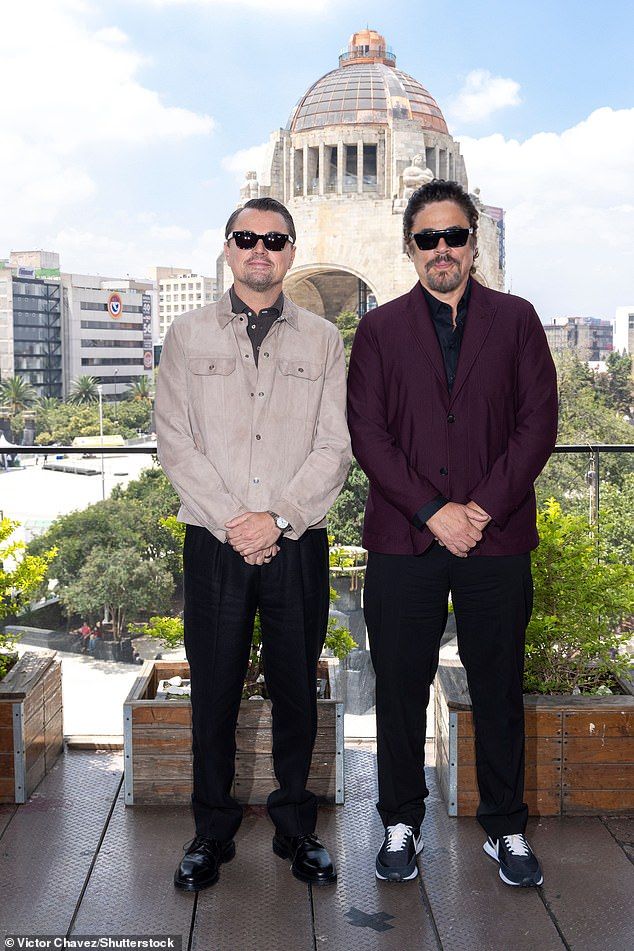 Leo wore a grey suede jacket with a blue polo and smart black trousers, shielding his eyes with a pair of sunglasses (pictured withBenicio del Toro)