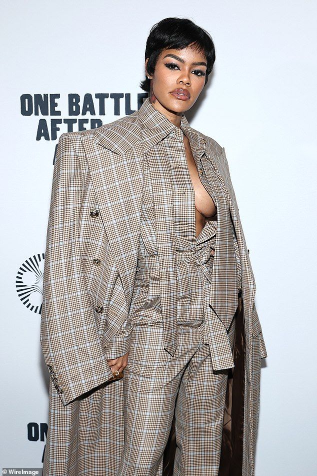 For the special occasion, Teyana Taylor turned heads as she went braless underneath a plunging, plaid jumpsuit that showcased her sternum tattoo