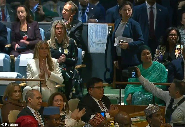 Melania appeared zoned out during her husband's fiery UN speech on Tuesday as she belatedly clapped when she appeared to realize the cameras were on her