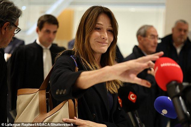 Supermodel Carla Bruni angrily ripped off a reporter's microphone and threw it on the floor after husband Nicolas Sarkozy was sentenced to five years in jail