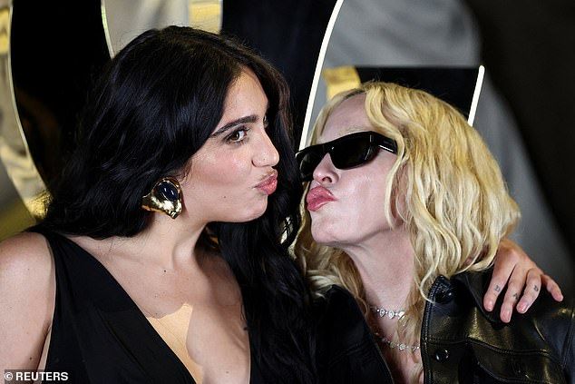 The pair looked in high spirits as they puckered up for the cameras