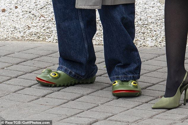 The singer, 20, sported a pair of quirky green frog clogs from JW Anderson as he and Jackie, 30, departed their hotel on Friday morning