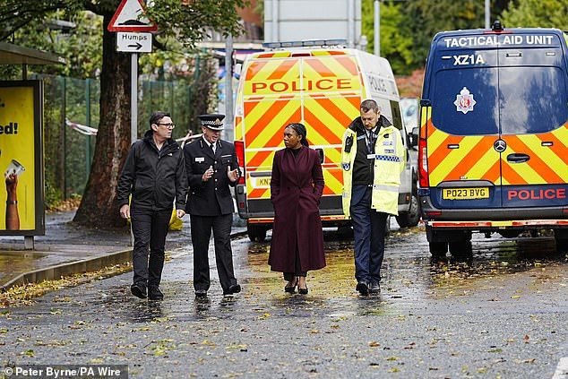 Badenoch was seen withGreater Manchester Mayor Andy Burnham (left) as the Conservative leader spoke to police officers amid the ongoing investigation