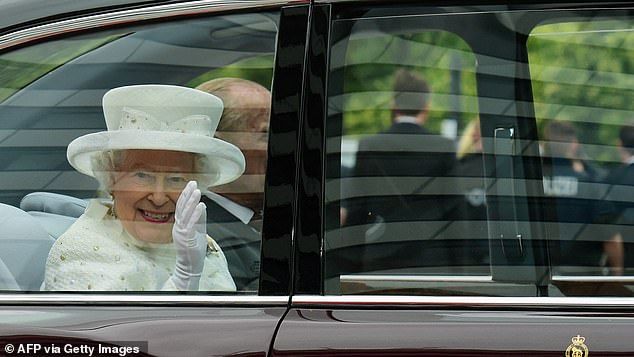 The Queen waves at onlookers in Berlin. Large crowds gathered throughout Germany to see Her Majesty