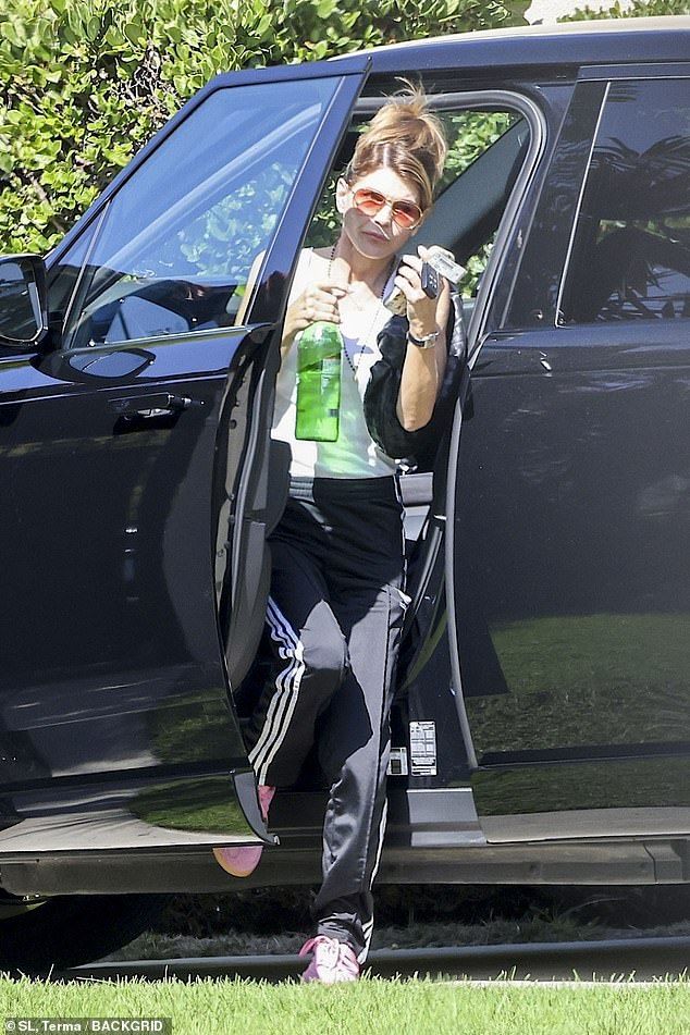 The star had on a white tank top which displayed her toned arms, as she added black-and-white adidas sweatpants that hugged her slender frame