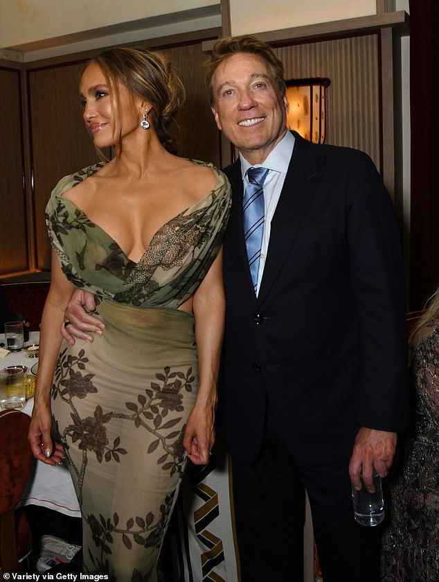 She shed her ensemble's spider-inspired corset for the party; pictured with talent agentKevin Huvane