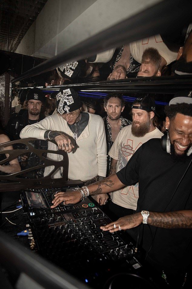 Snaps from the fun-filled evening see MGK - real name Colson Baker - letting loose at the celebrity hotspot - co-owned by movie star Jason Momoa, film producer Jason McNab and designer Marc Jacques Burton